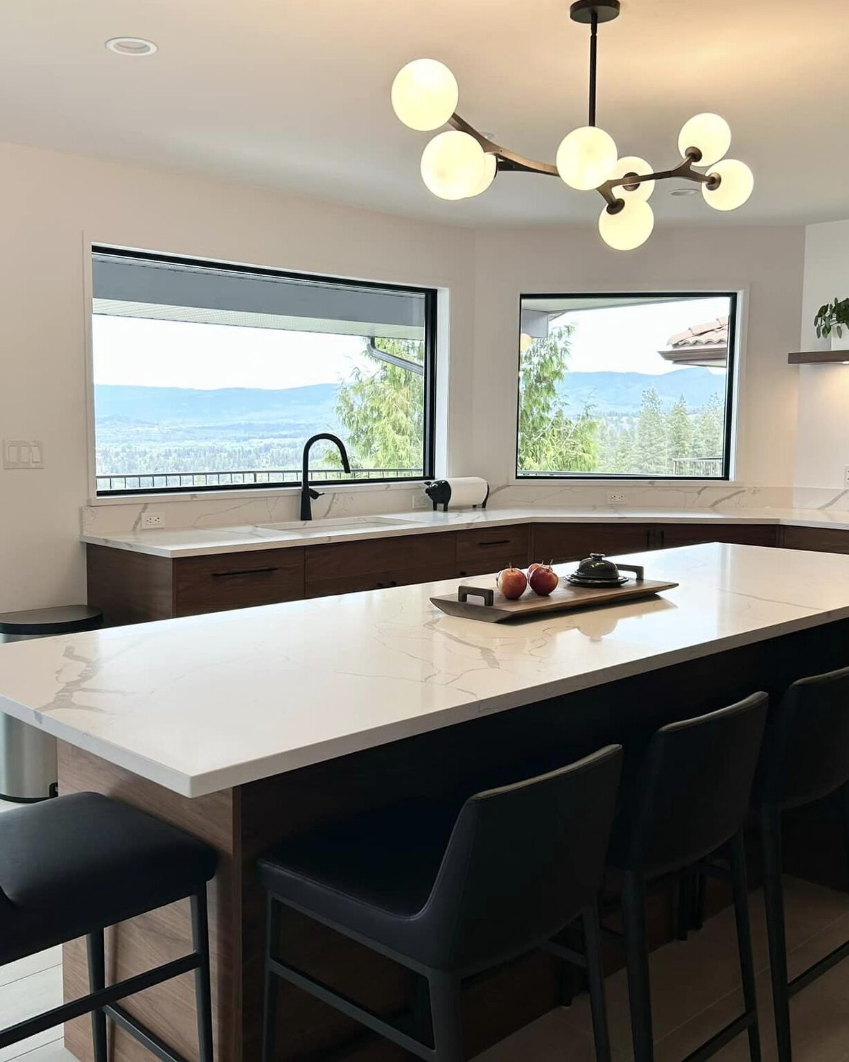Complimenting this open kitchen design with large views of the neighboring vineyard and Okanagan lake views.